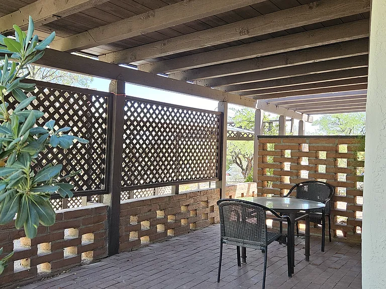 Front covered patio. Utility/laundry room is accessible from this patio. There's a gas grill on the far side.