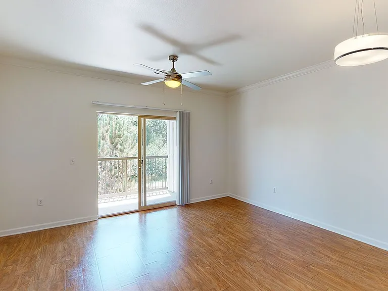 Apartment living room with wood-style flooring and patio or balcony.