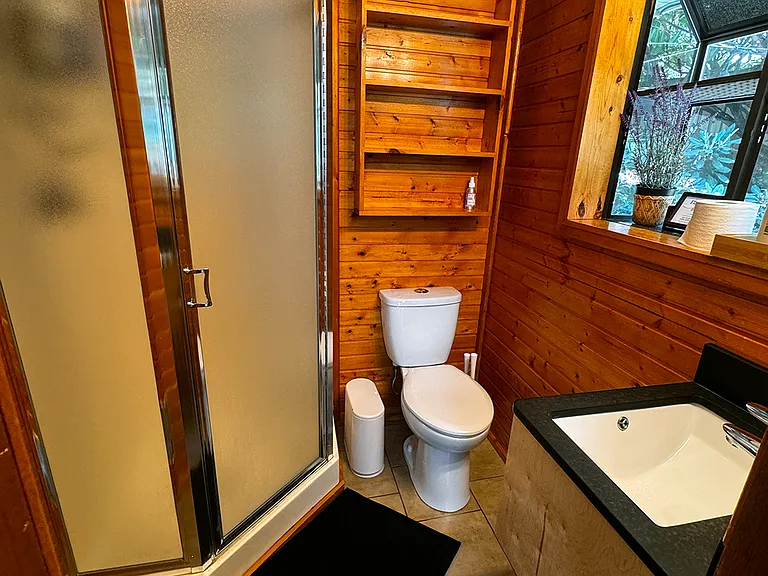 Small bathroom with standing shower closest to kitchen, living room, dining room and bedroom 4.
