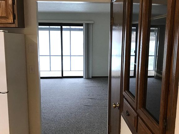 Kitchen looking into LR, Glass front custom cabinet.