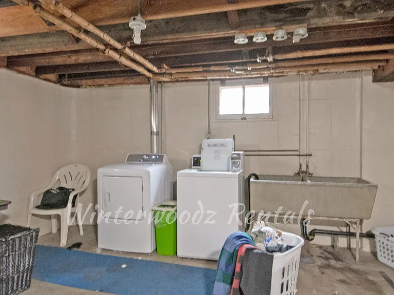 Coin Operated Laundry in Basement with Storage Space