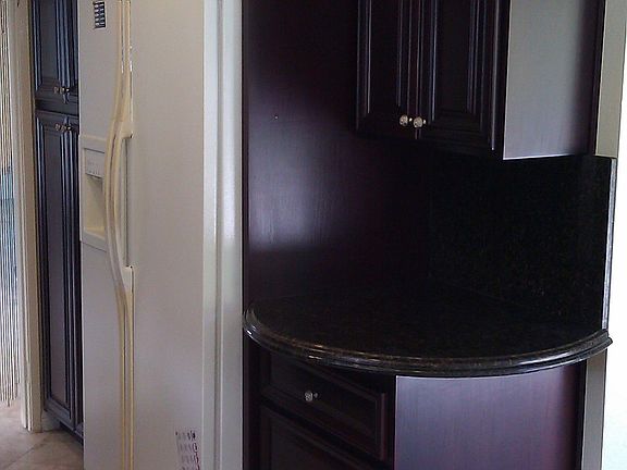 Kitchen refrigerator and corner counter.