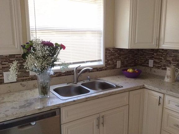 New quartz counters, new sink and faucet with garbage disposal and stainless steel new dish washer.
