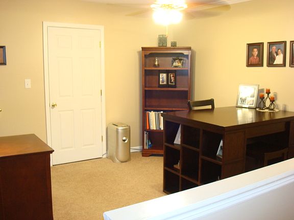 Other half of room to the right of stairs. Makes a great office or man cave!