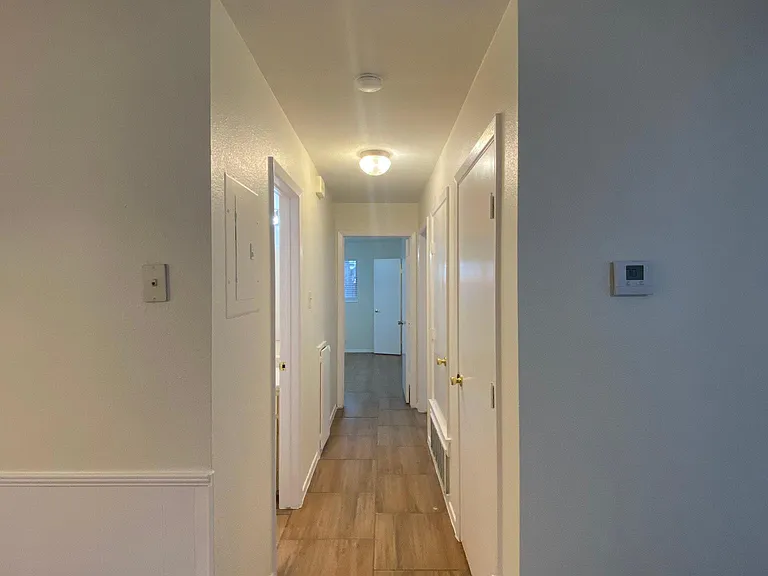 Hallway to other two bedrooms and bathrooms