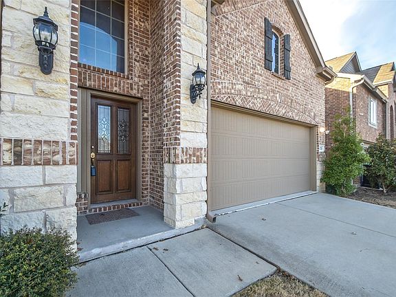 front of home featuring stone and brick