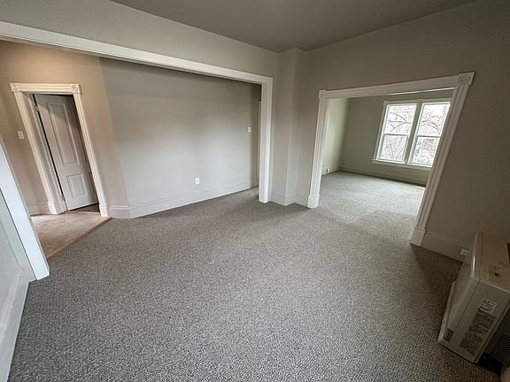 Family room. New wall-to-wall carpet, fresh paint, and new windows. High efficiency gas heater. Living room to the right, and bedroom through the door to the left.