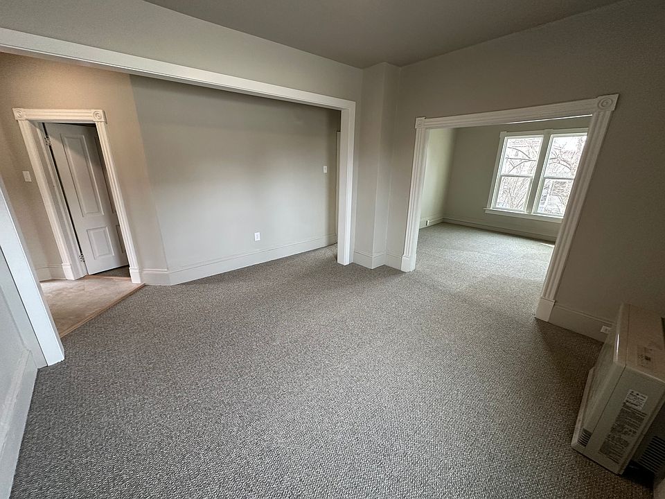 Family room. New wall-to-wall carpet, fresh paint, and new windows. High efficiency gas heater. Living room to the right, and bedroom through the door to the left.