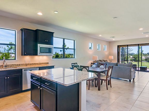 Kitchen with flow-through layout to the Dining and Gathering Room