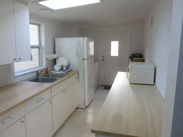 Kitchen with washer and dryer to the left by back door