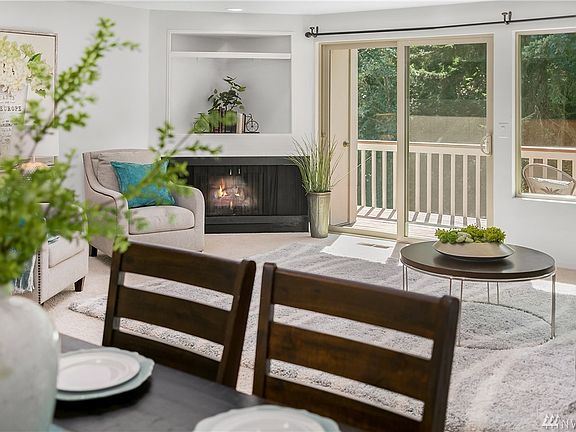 Very spacious main floor living area with gas fireplace and balcony overlooking quiet, tree lined street. No neighbors on the opposite side of the street and no neighbors behind you, just mature trees!