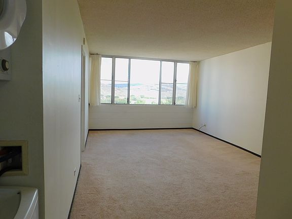 View of living/dining area toward the mountains and golf course