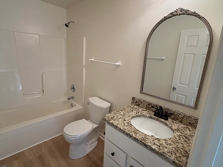 Lovely bathroom includes new vanity, new granite countertops, and stylish mirror