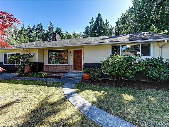 Front view of the home. Notice the nice walkway leading up to the front door as well as the large picture window that gets a lovely view of the color in the tree out front.