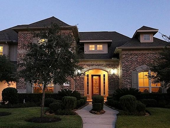 THIS IMPRESSIVE HOME'S EXTERIOR OFFERS MANICURED LANDSCAPING, NOTABLE BRICK DESIGNS, DOUBLE PANED WINDOWS, AND AN ATTRACTIVE  COVERED PORCH WITH A GLASS LEADED FRONT DOOR.