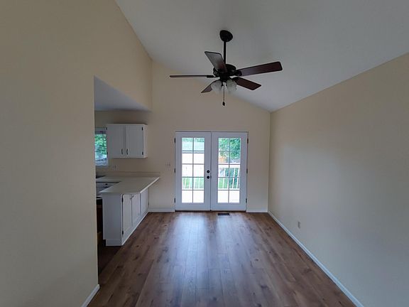 Dining room, cathedral ceilings, ceiling fan open to kitchen and living room