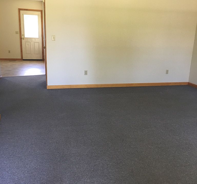 living room has double window looking off front porch