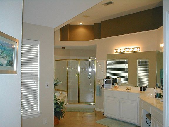 Large master bath joins master bedroom with separate sitting area