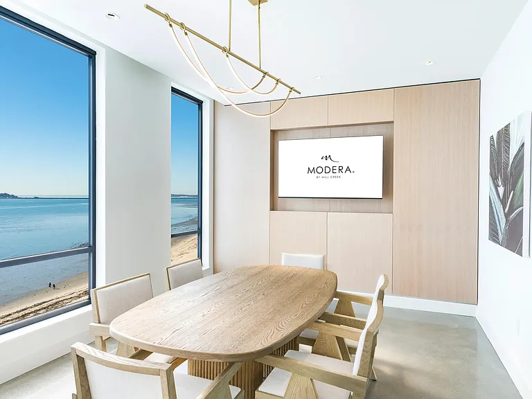A refined conference space with warm wood tones and expansive water views designed to impress.