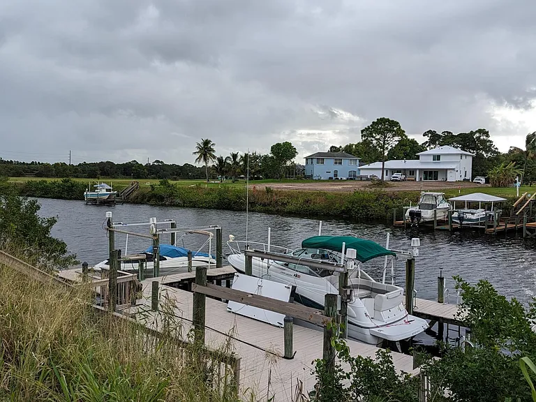 View of boat dock and C24 canal from the levee behind the home.