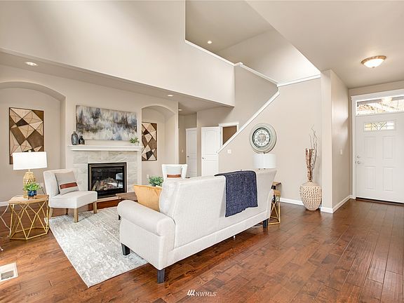 Living room with front entry and staircase. 