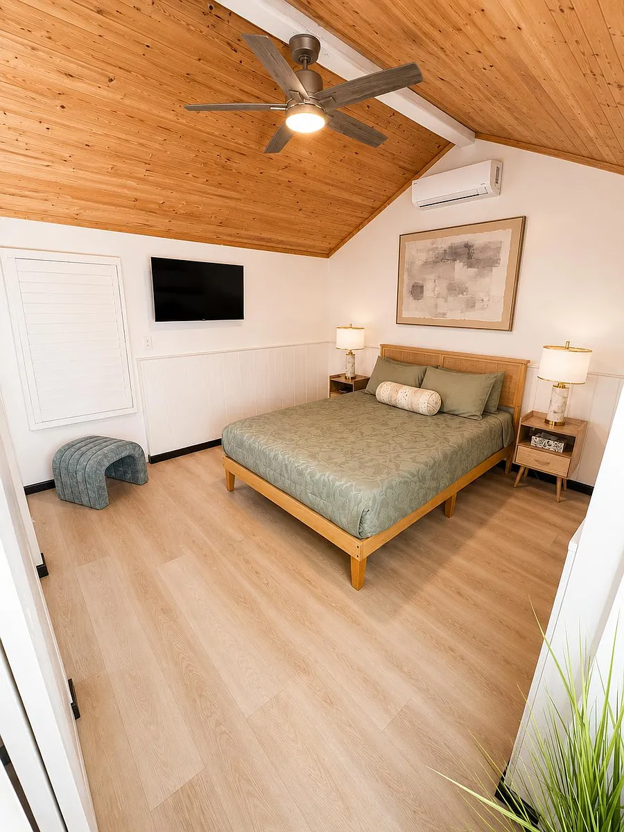 Vaulted wood ceiling bedroom with queen bed, split A/C, ceiling fan, and nightstands for convenient everyday living. - State Highway 138