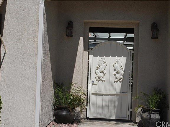 Private locked gate to Tropical courtyard