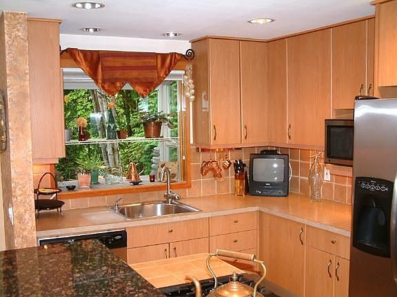 Completely updated kitchen with island stove and extra cabinets.