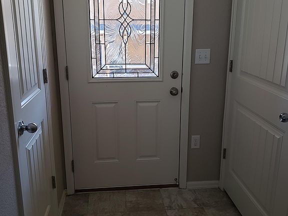 Entrance with coat closet and powder room
