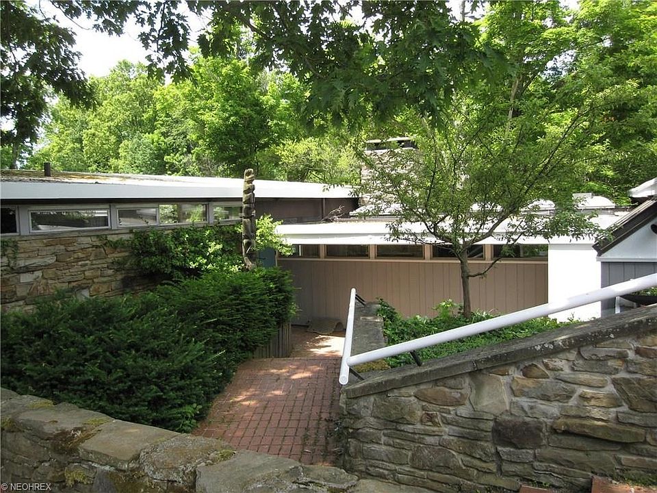Home front entry has beautiful Ohio river rock stone and brick steps.