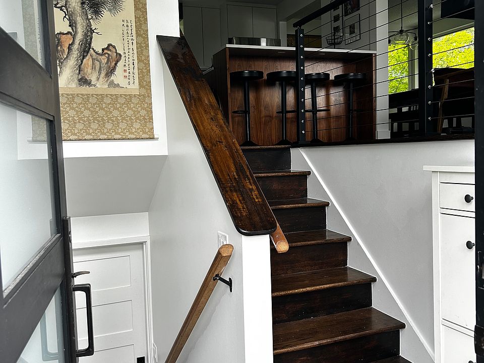 Entrance to main rental--beautiful tempered glass double doors. Compact shoe storage for convenience. Upstairs to bedrooms, two bathrooms, and kitchen. Downstairs to rec room, one bathroom, study, and laundry room. Decks to entertain or lounge both levels