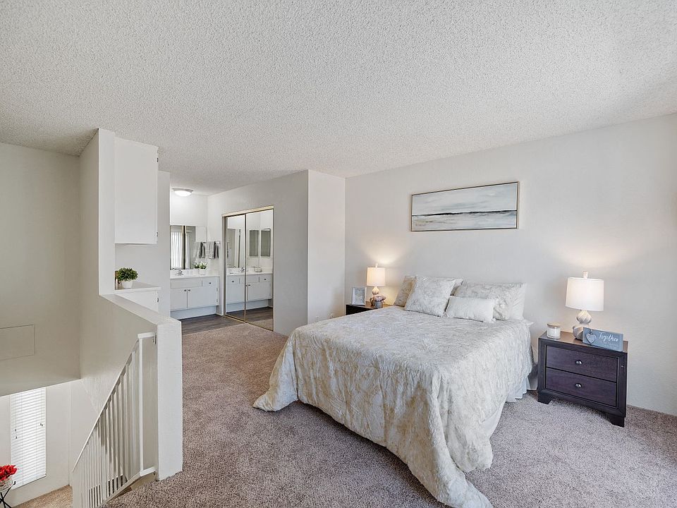 Spacious bedroom at the Terrace apartment in Tarzana, CA with mirrored closets and ample natural light