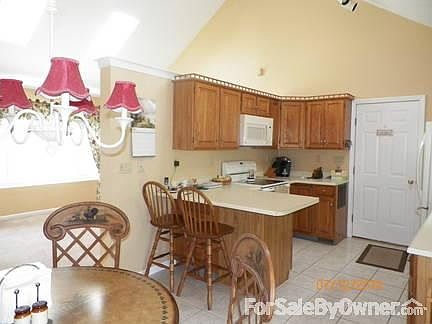 Kitchen/Dining Area
						:
						Beautiful neutral tone walls w/cathedral dividing kitchen and formal living area
