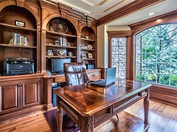 The handsome den features bookshelves and built-in desk, making the room a catalyst for productivity.