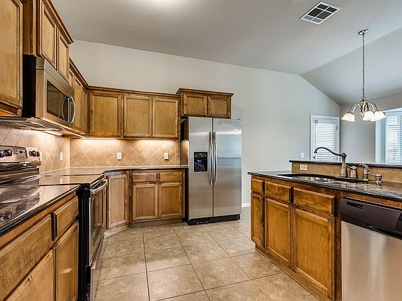 Large kitchen with vaulted ceilings, lots of storage and stainless appliances