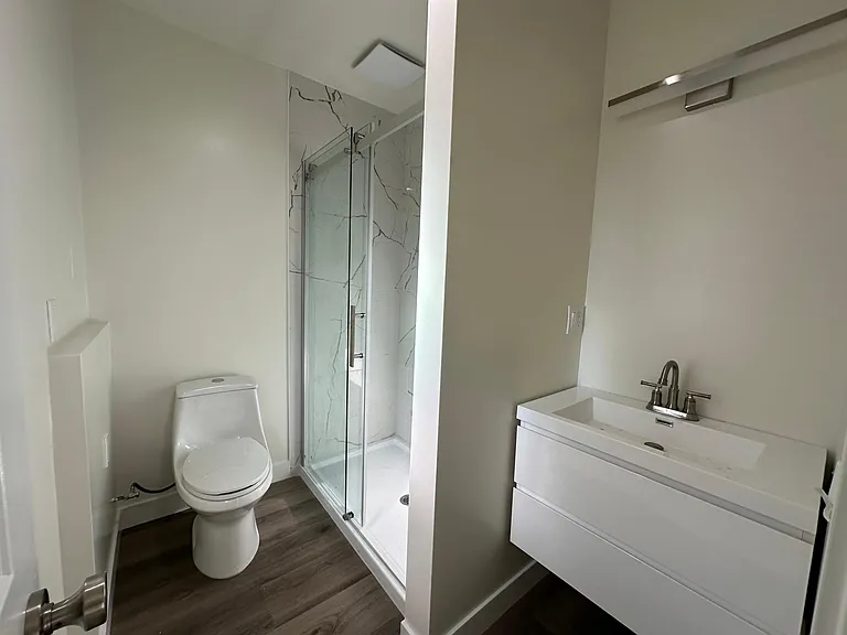 Bedroom #2 bathroom with beautiful glass walk in shower and sink