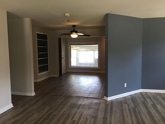 Open concept living to dining space with window to the water