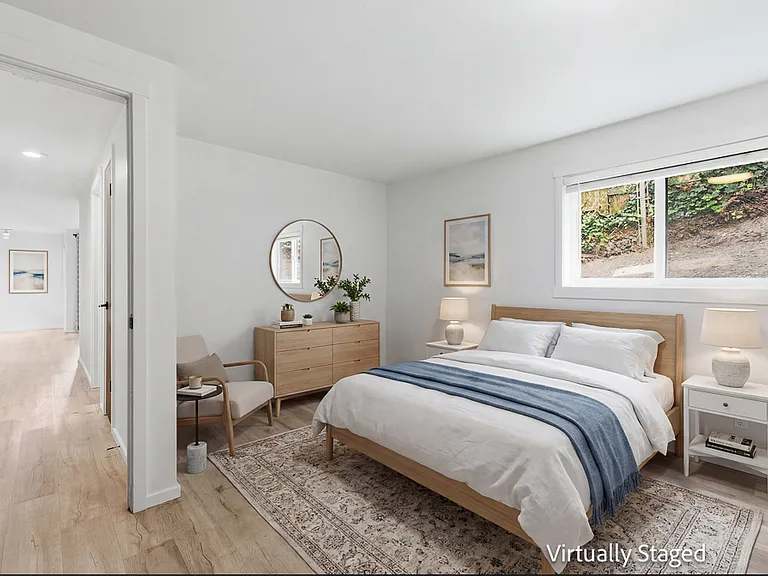 Primary bedroom staged with queen bed
