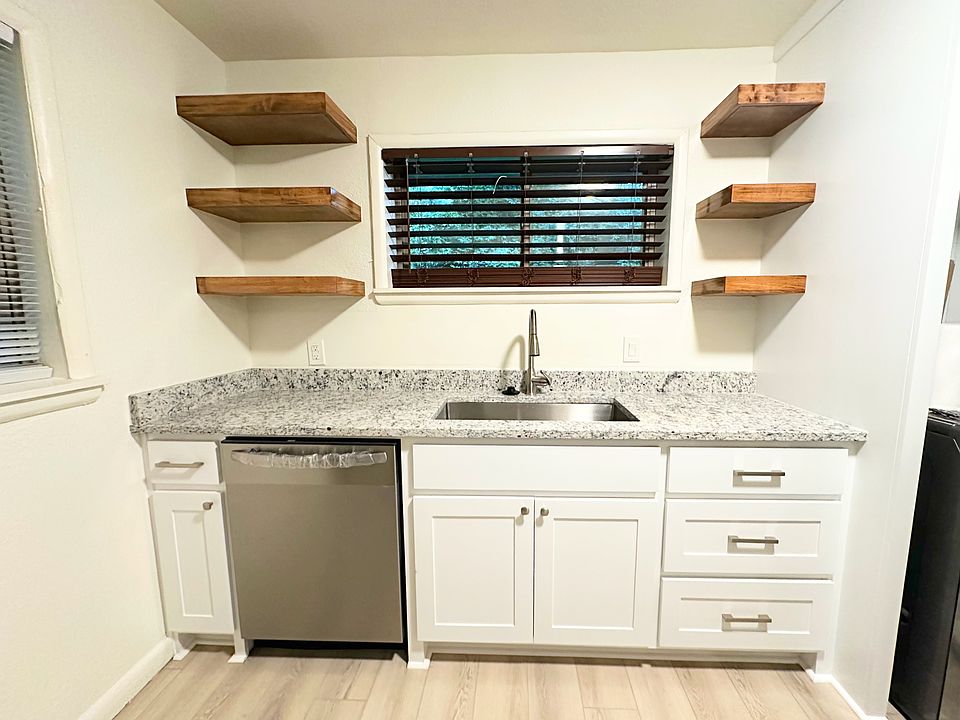 Brand new custom kitchen cabinets, open shelves, granite counter tops, dishwasher, fixtures, and new LVP flooring throughout.