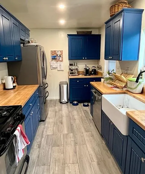 Newly Painted kitchen with new fridge-freezer and dishwasher (older gas stove)