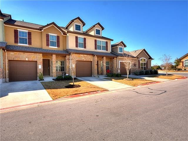 Front view of home, cozily sitting third to the left