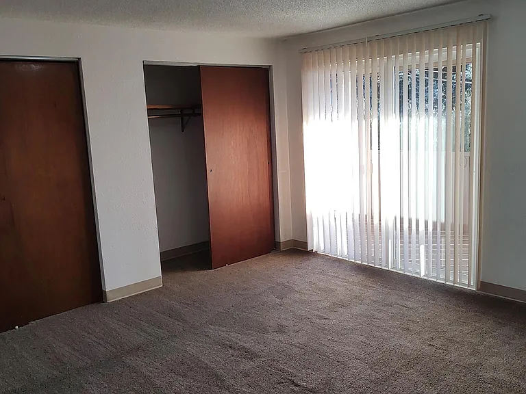 Master bedroom with double closets and sliding door to the covered deck.