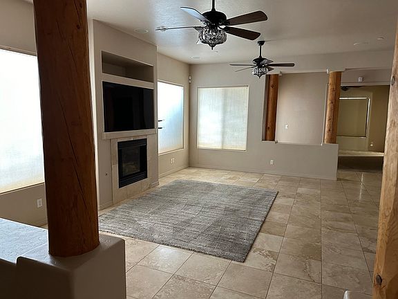Great room with fireplace and area rug