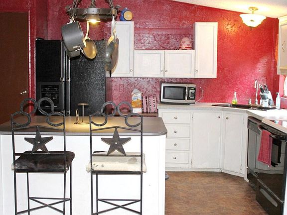 Colorful Kitchen has center island that can turn into a breakfast bar. The appliances are helpful, t