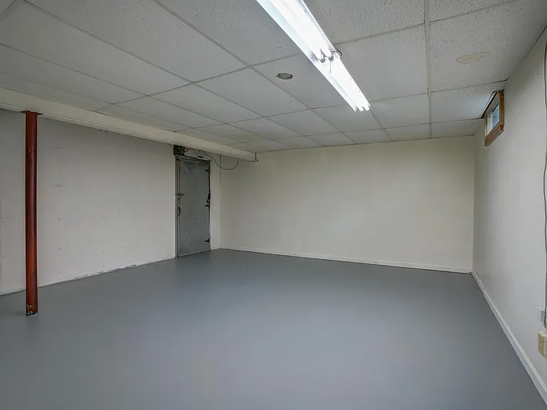 Laundry/mechanical room access through metal door on left