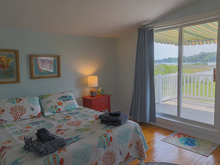 Upstairs bedroom with private balcony. Queen bed