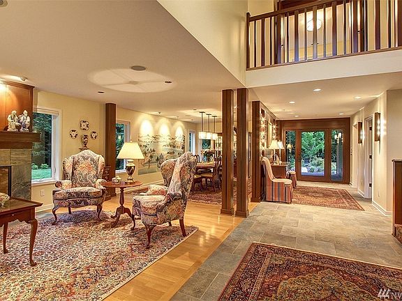 The double story foyer with contemporary lighting by Fine Arts Lamps, slate-like porcelain tile flooring.