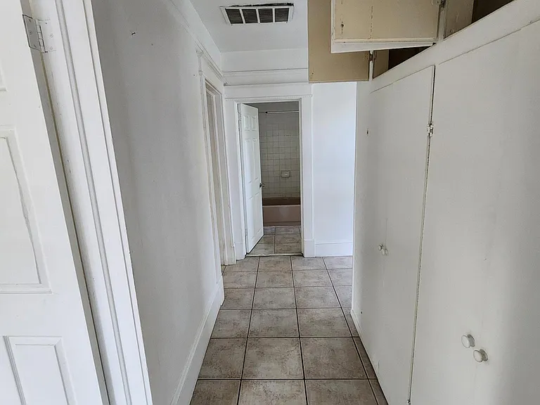 Hallway from Living Room. Bedroom on left. Built in storage on right