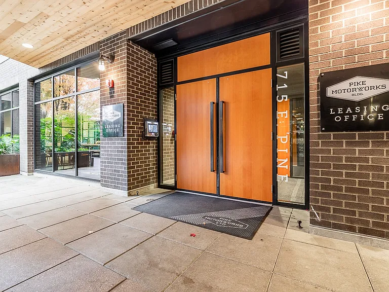 Leasing Office Entrance with Glass Windows and Brick Facade