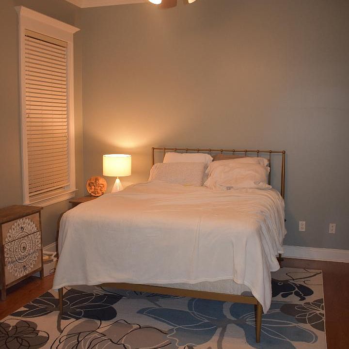 Primary bedroom downstairs with en suite bathroom and walkin closet.